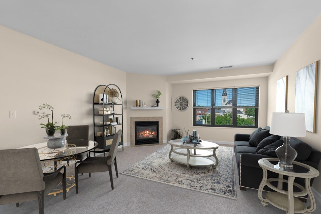 Living room with fireplace in independent living apartment.