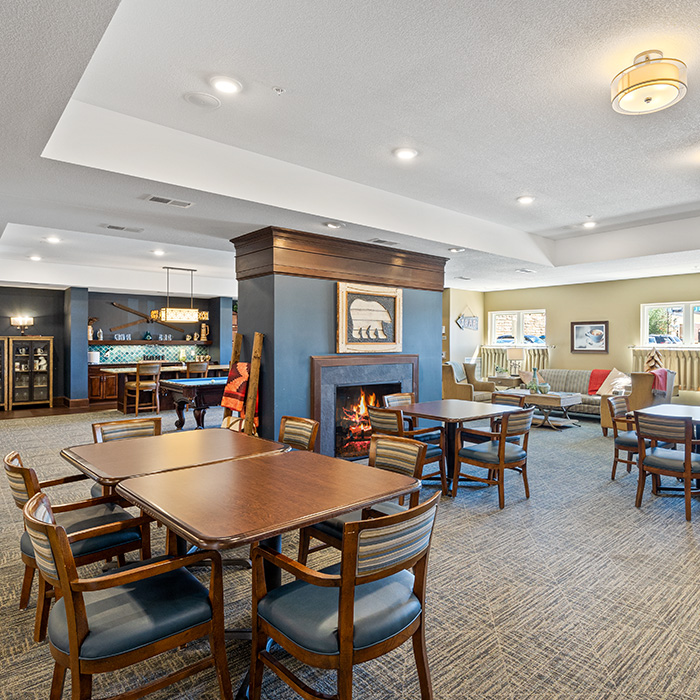 Pub room with fireplace and table seating.