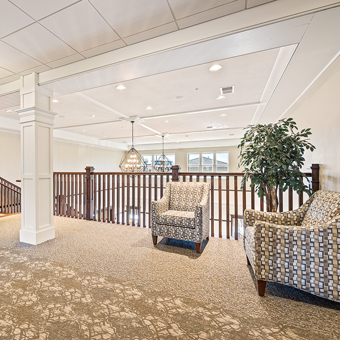 Upholstered seating near the grand staircase.