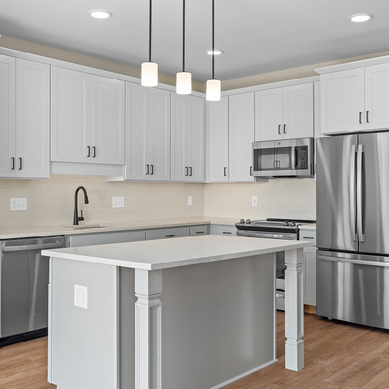 Kitchen with island and stainless steel appliances in an independent senior living apartment.