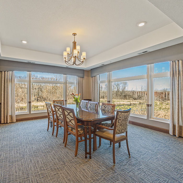 Private dining room with corner windows and a chandelier.