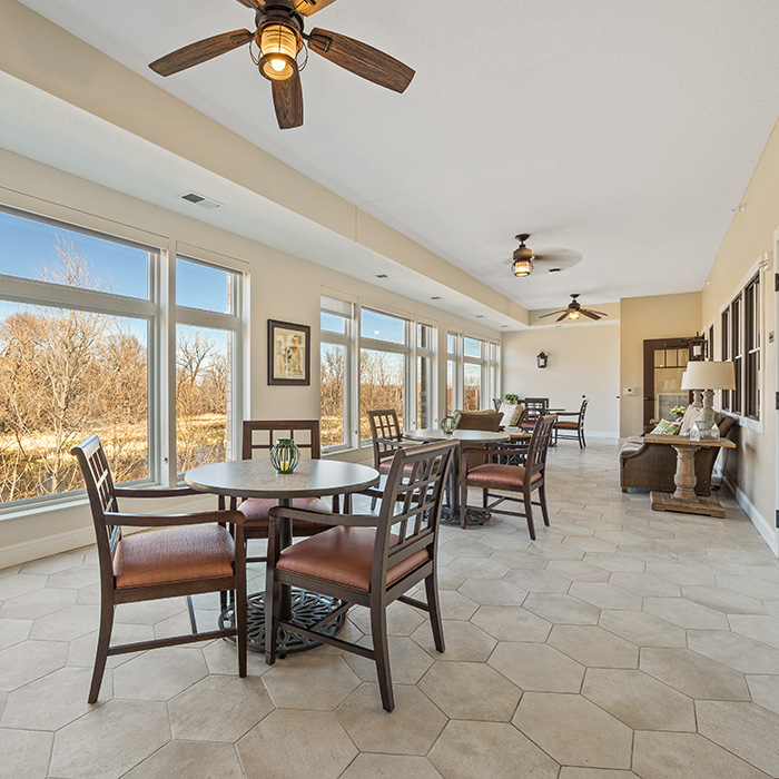 Sun porch with comfortable seating and a beautiful view.