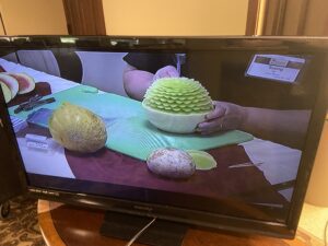 Image of fruit carvings being created on a television.