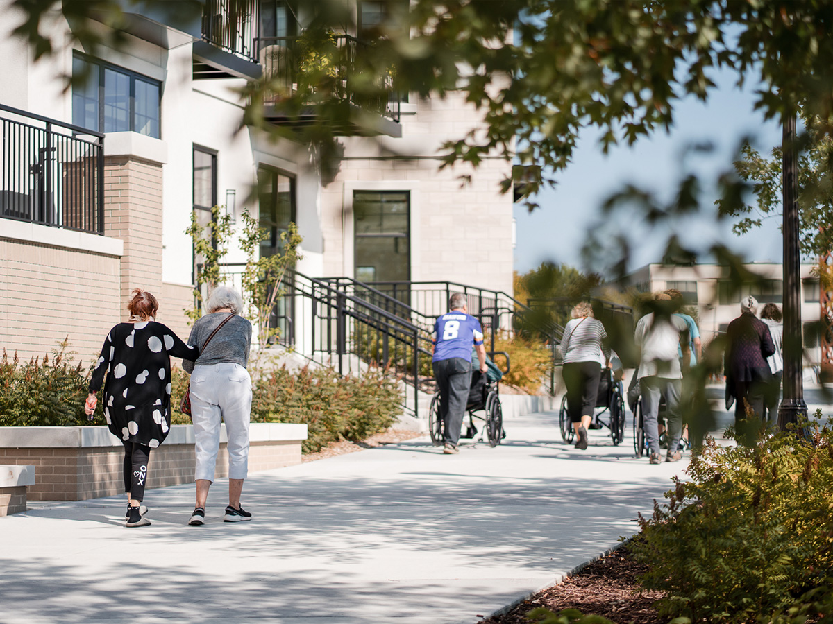 image of people walking outdoors at a Presbyterian Homes community