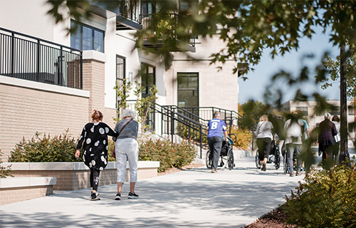 image of people walking outdoors at a Presbyterian Homes community