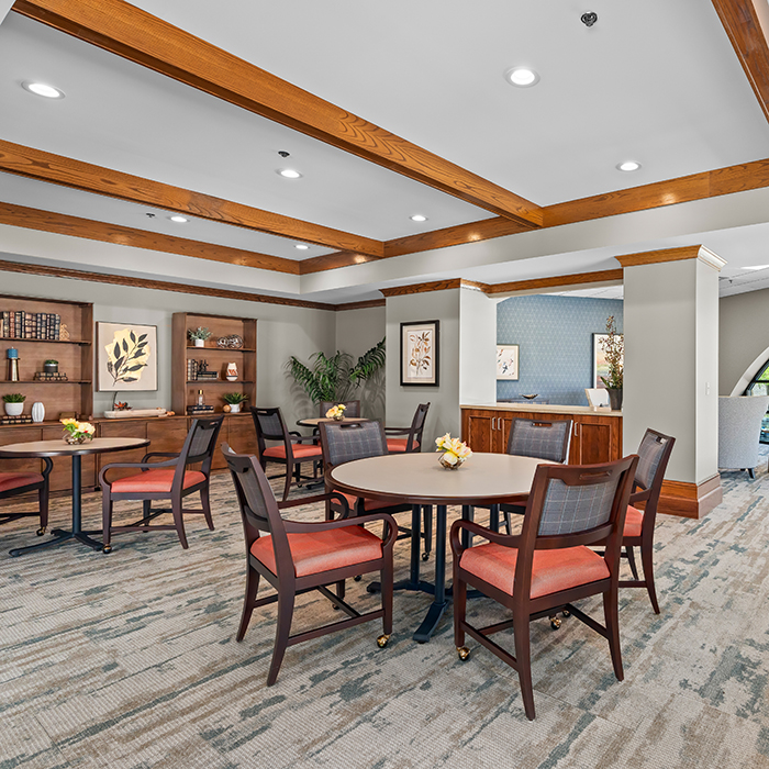 Tables and chairs in the corner lounge.