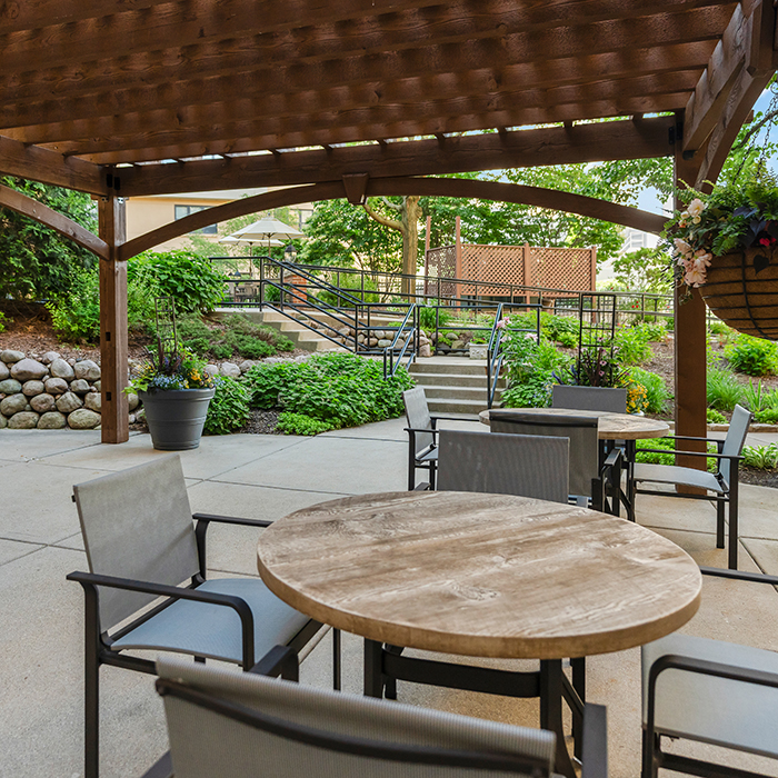 Outdoor tables and chairs under the pergola.