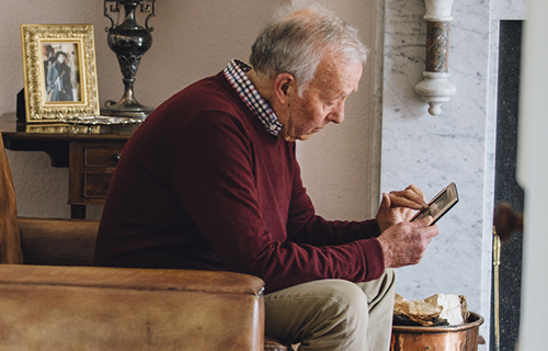 image of older man looking intently at a portrait